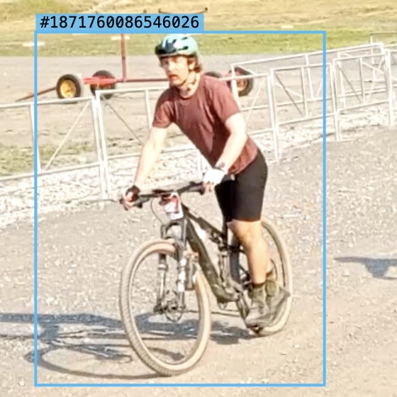 A rider on the video with a blue detection box drawn around them, labelled with a long numeric track id